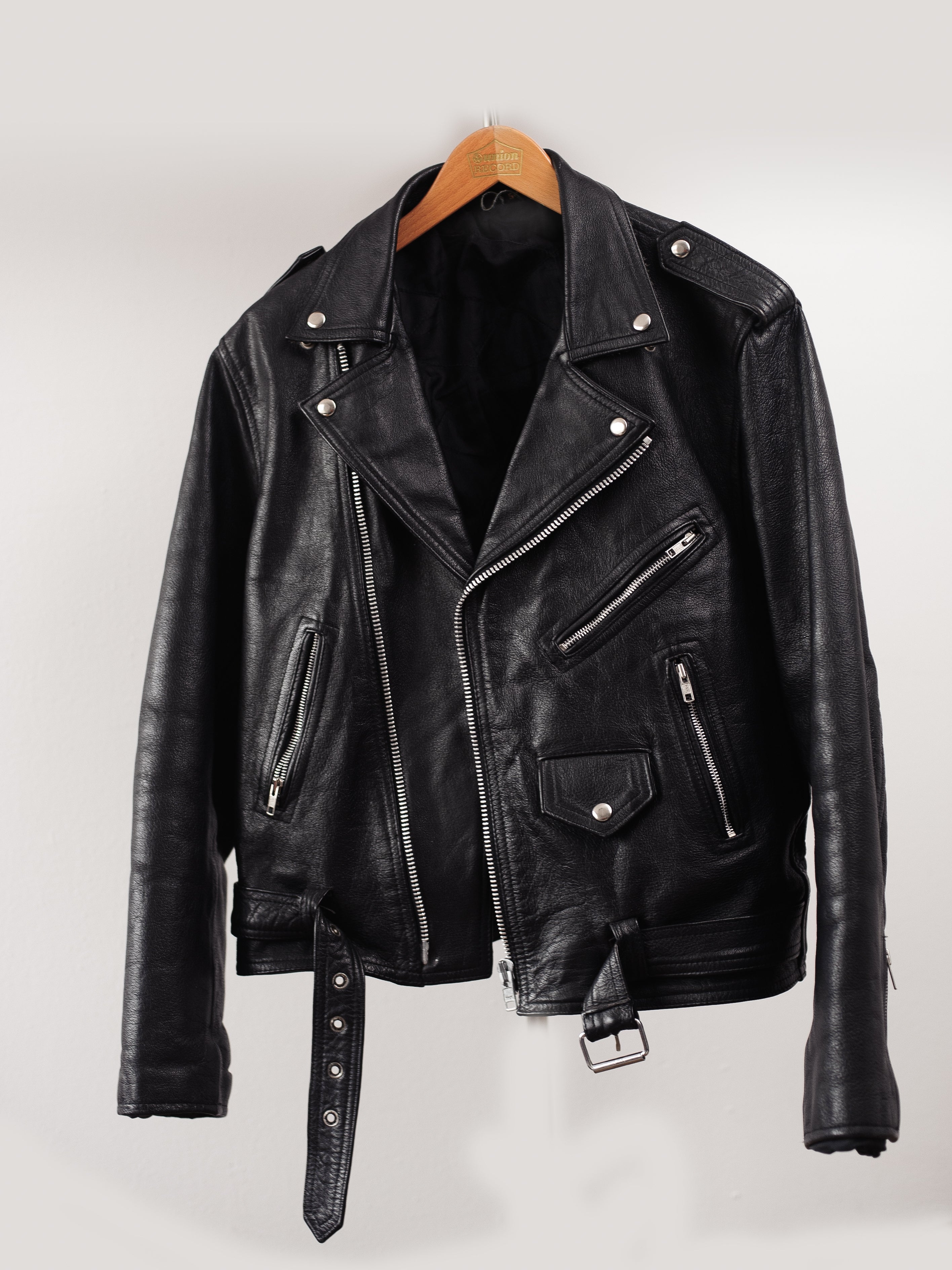 A black leather jacket on a hanger
