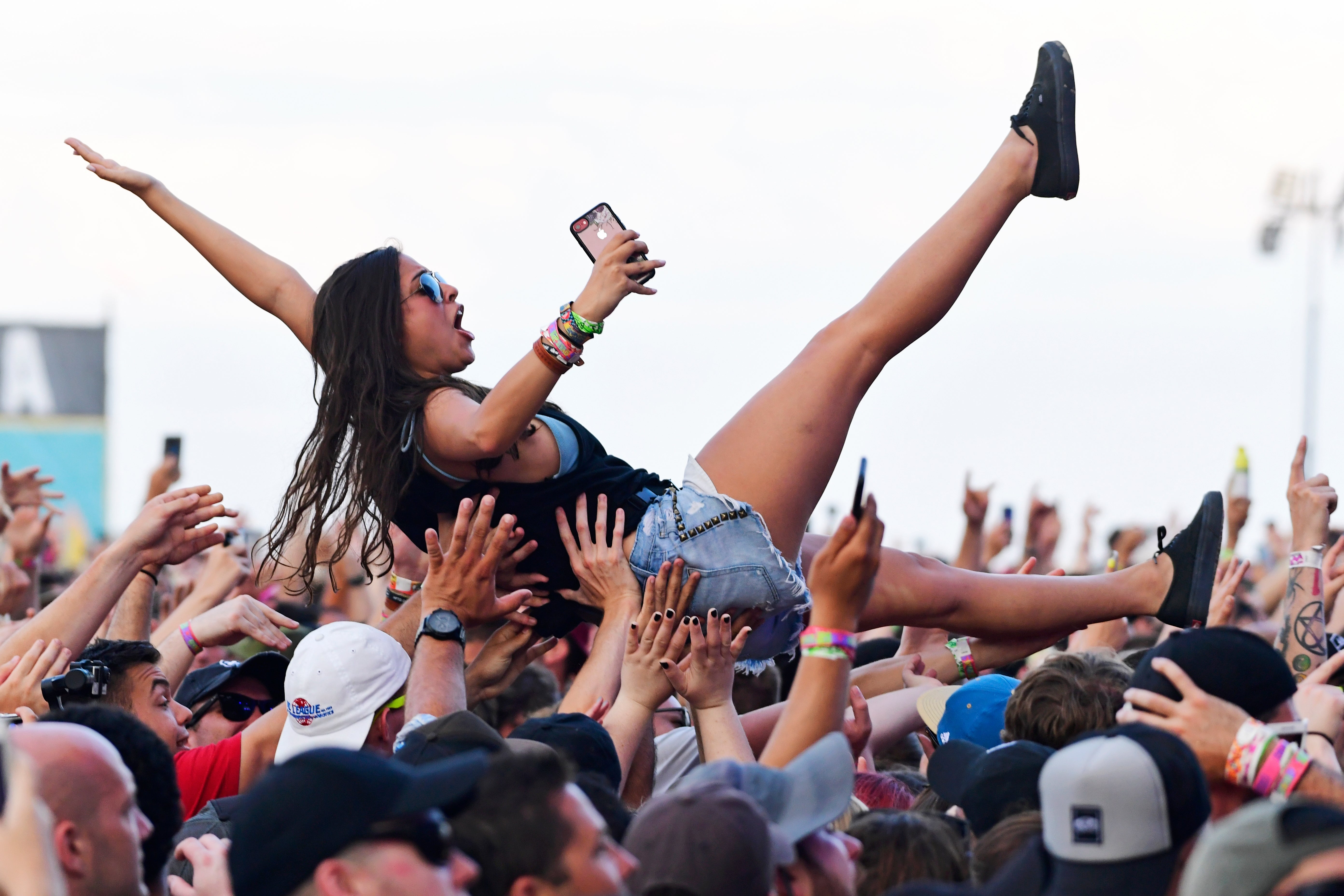 A woman crowdsurfing