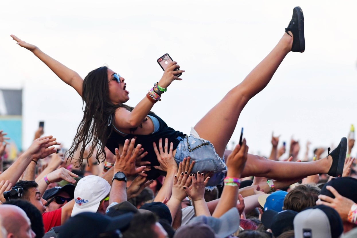 A person crowdsurfing at a concert