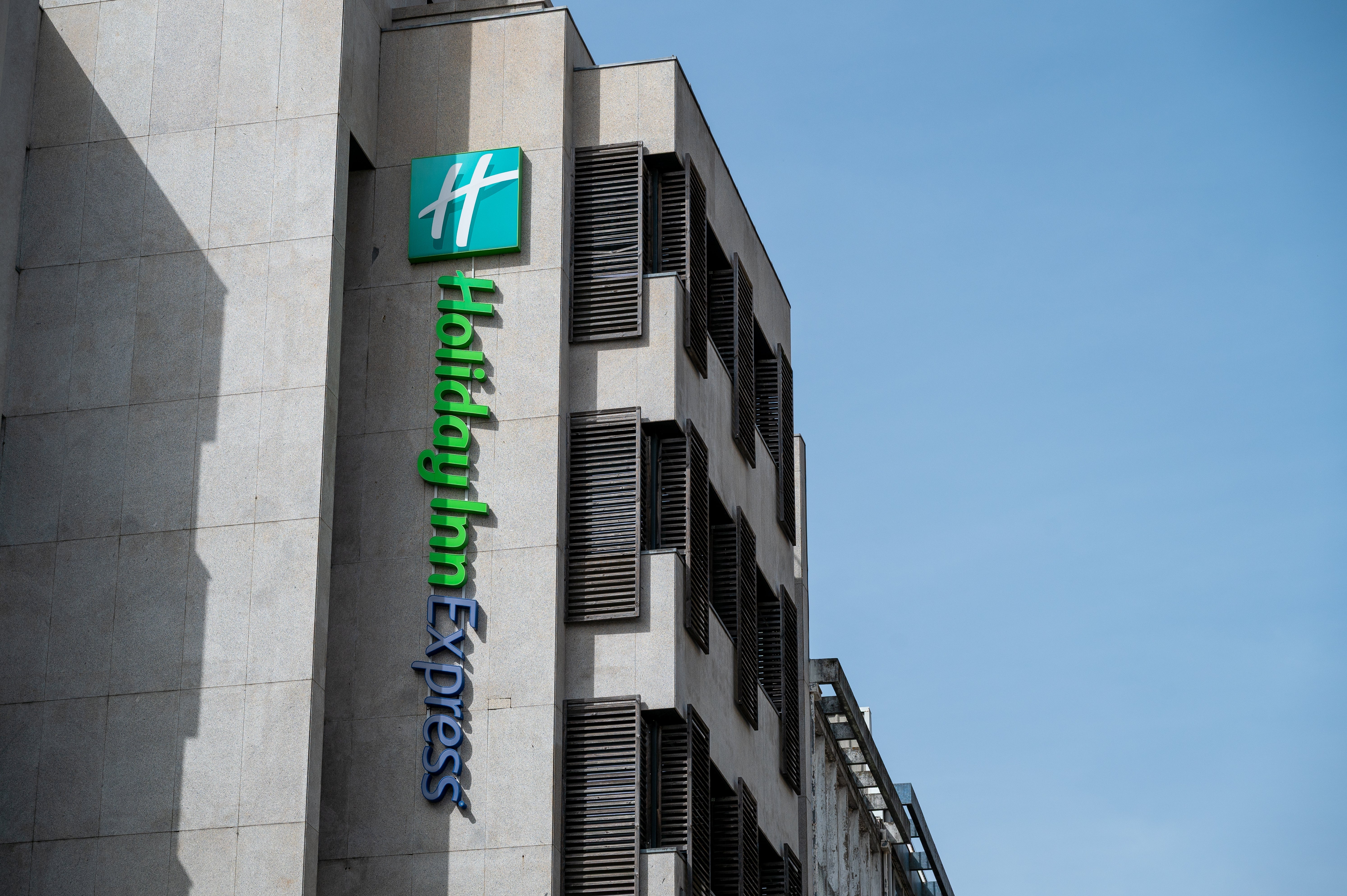 Holiday Inn Express gathering with its logo and sanction connected the facade nether a wide sky