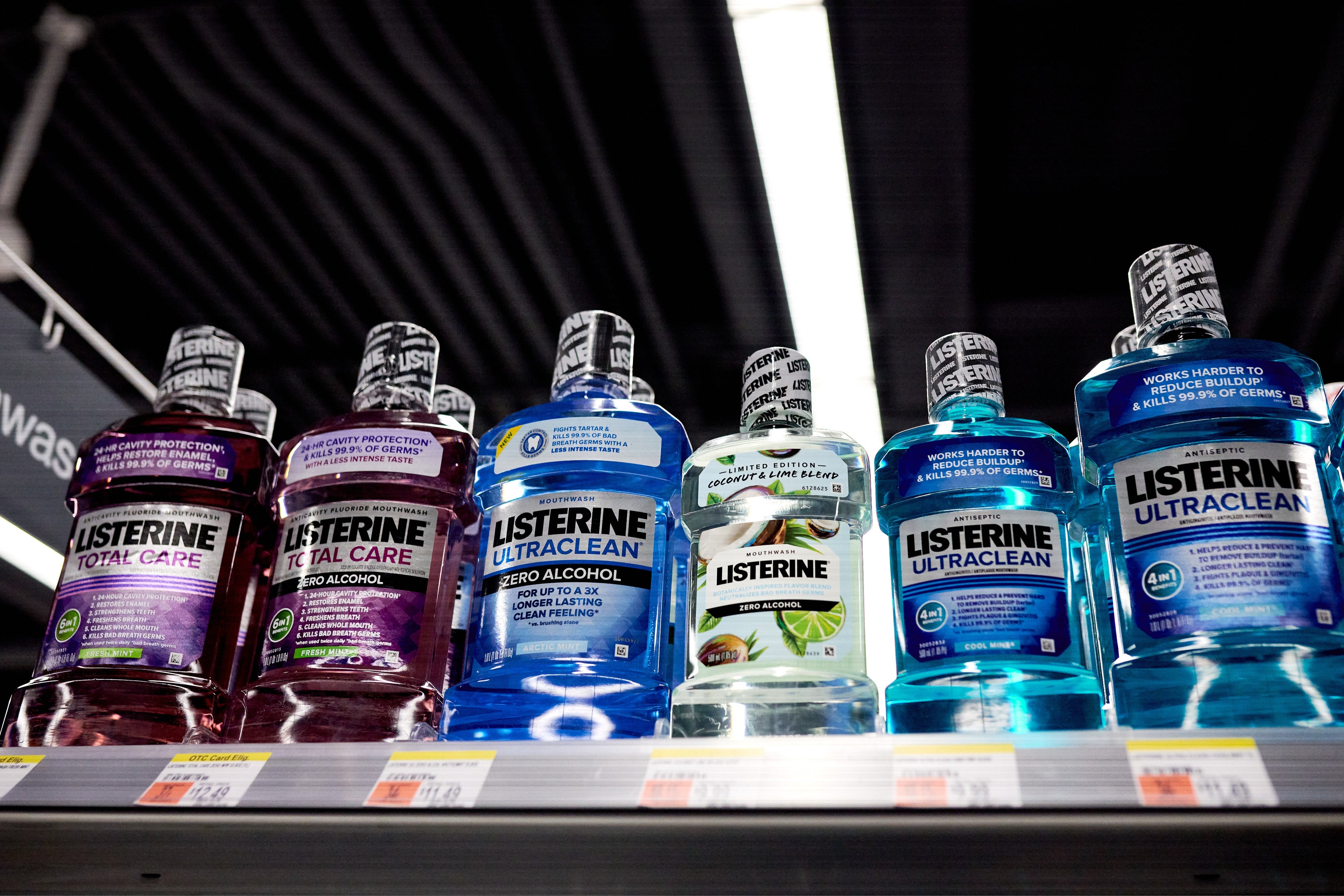 Various Listerine mouthwash bottles connected a store shelf, each with antithetic labels and descriptions, showcasing merchandise variety
