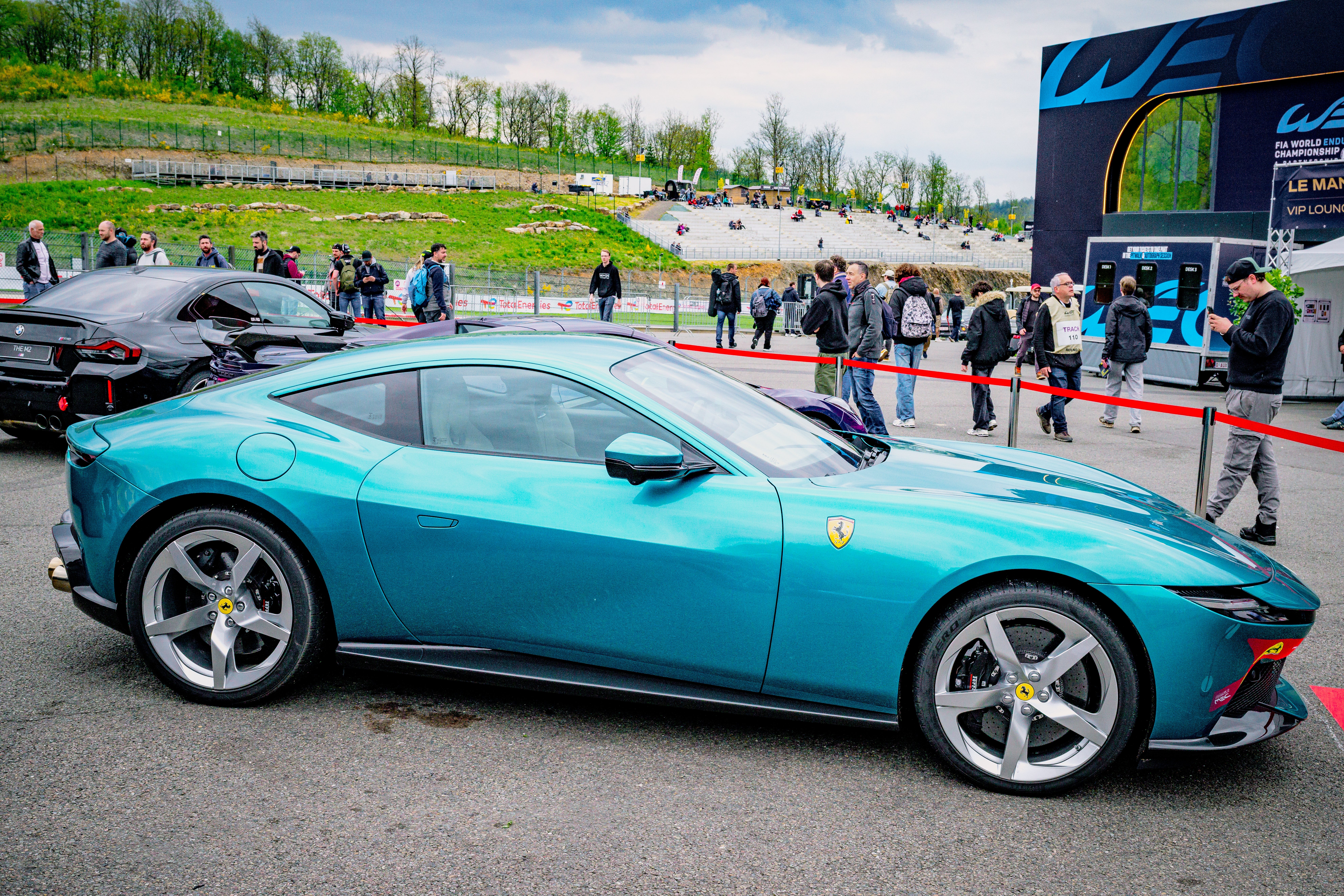 Sleek, modern sports car displayed astatine an outdoor lawsuit with radical successful the background