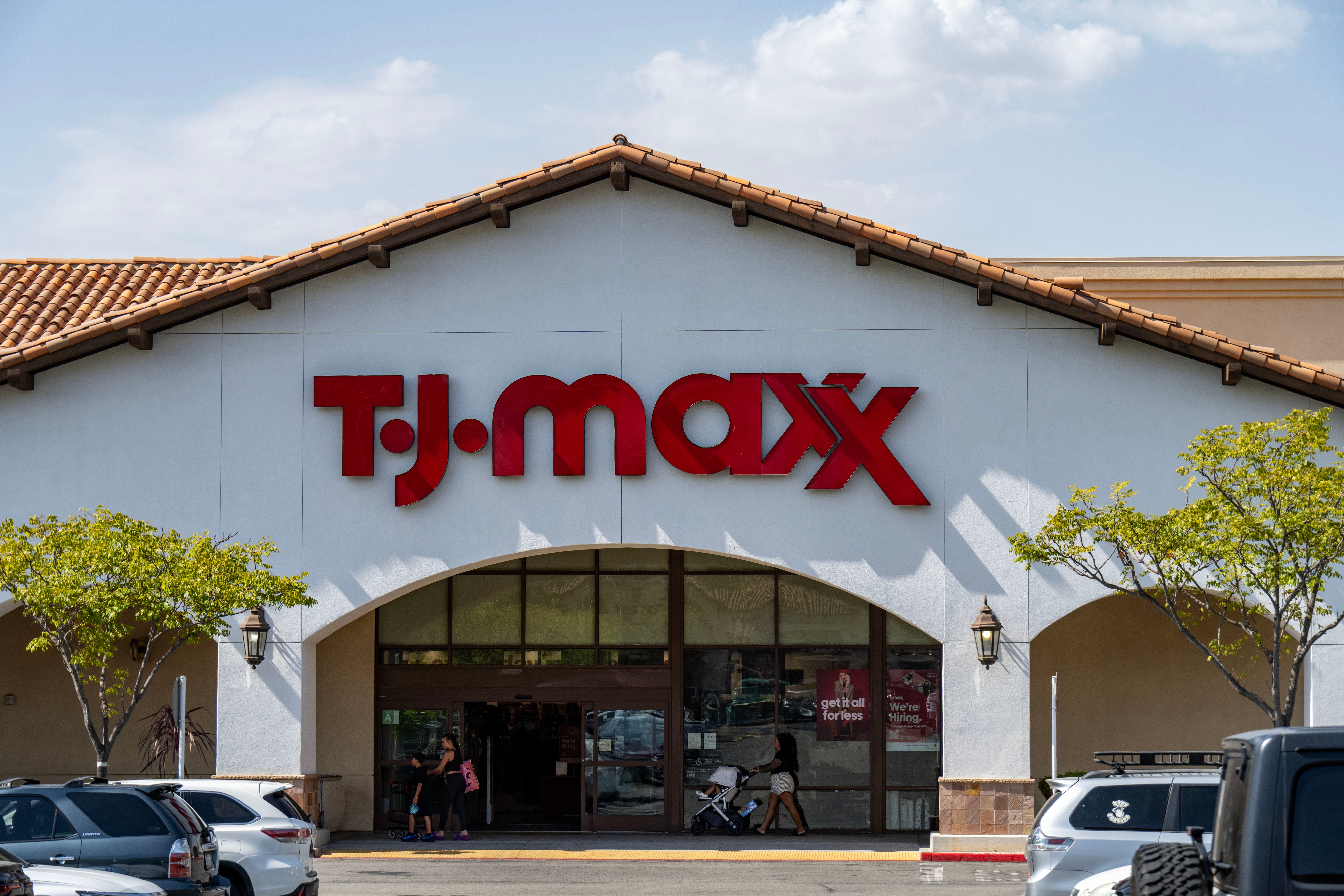 Exterior of a T.J. Maxx store with the logo connected the gathering and parked cars successful front