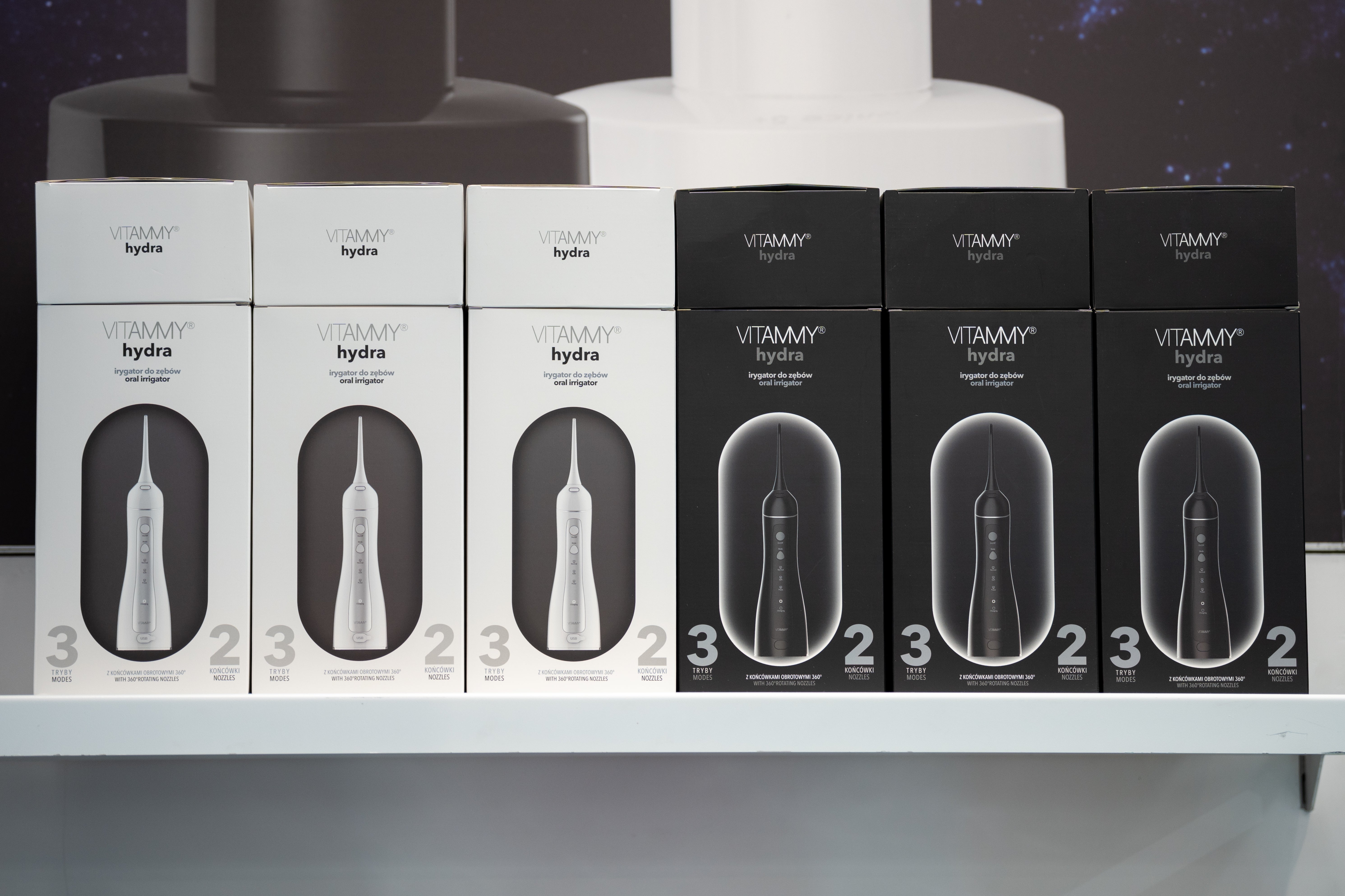 Shelf displaying aggregate boxes of Vitammy Hydra dental irrigators successful achromatic and achromatic packaging