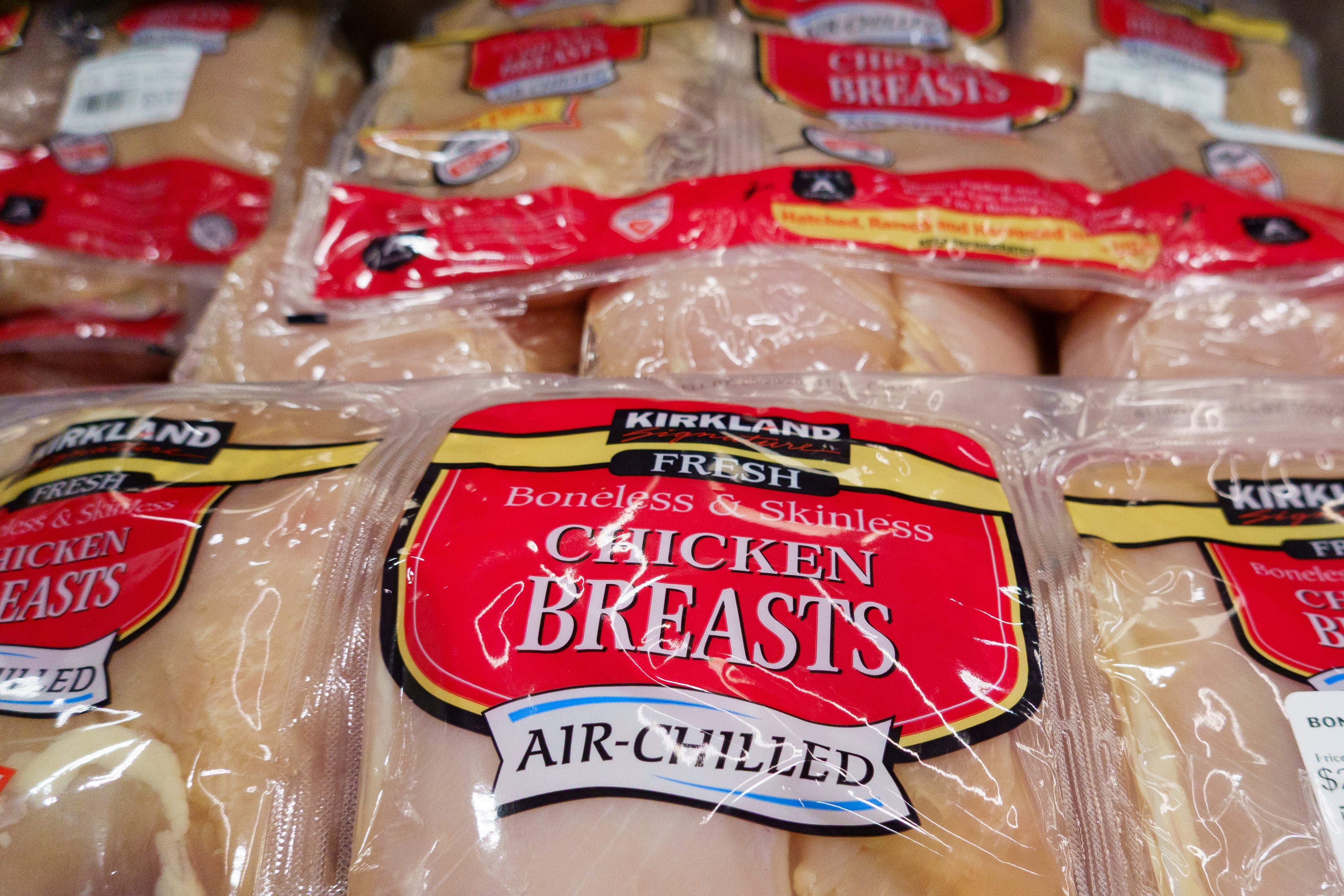 Packages of Kirkland boneless, skinless chickenhearted breasts labeled arsenic air-chilled, arranged connected a store shelf