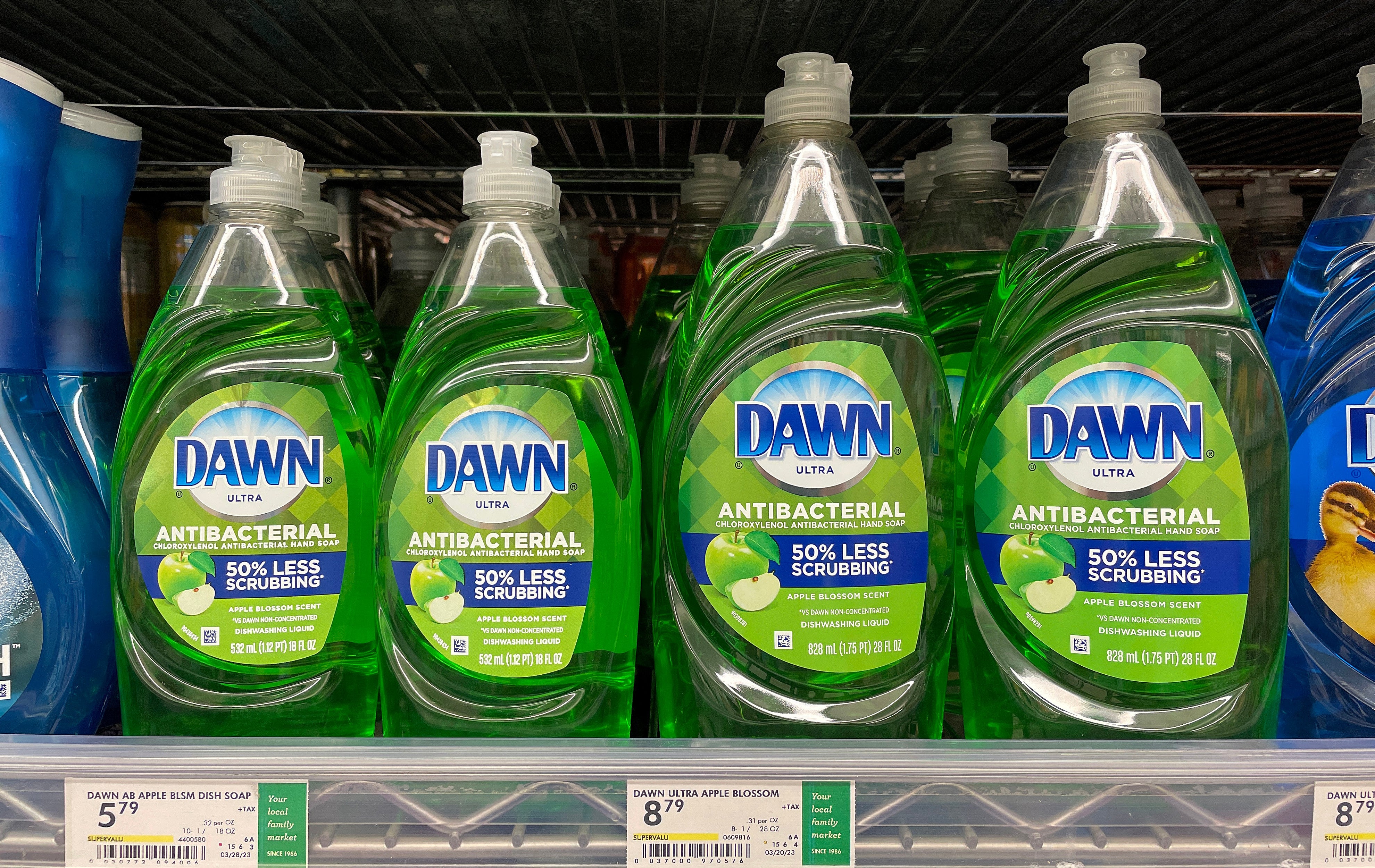 Dawn antibacterial crockery soap bottles connected a store shelf, labeled "50% little scrubbing."