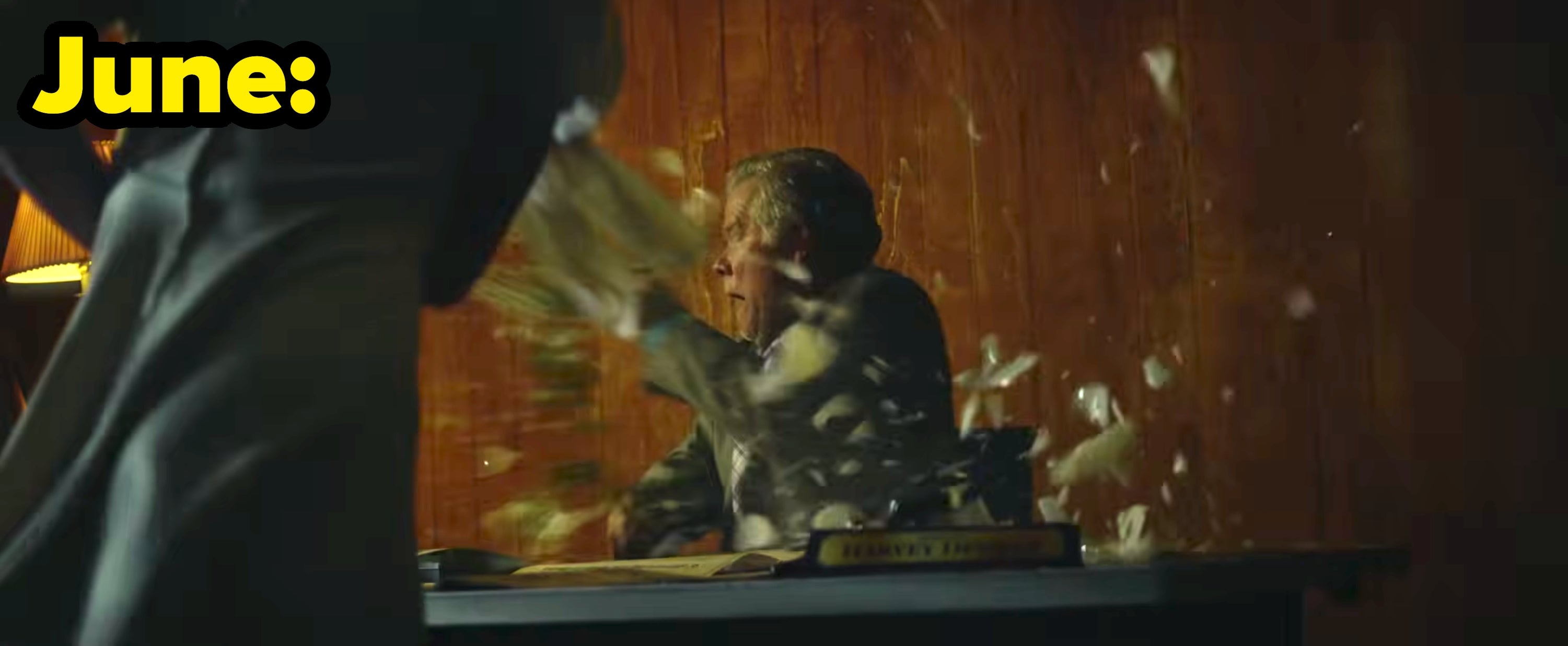 June smashes a vase as a man reacts in shock at his desk