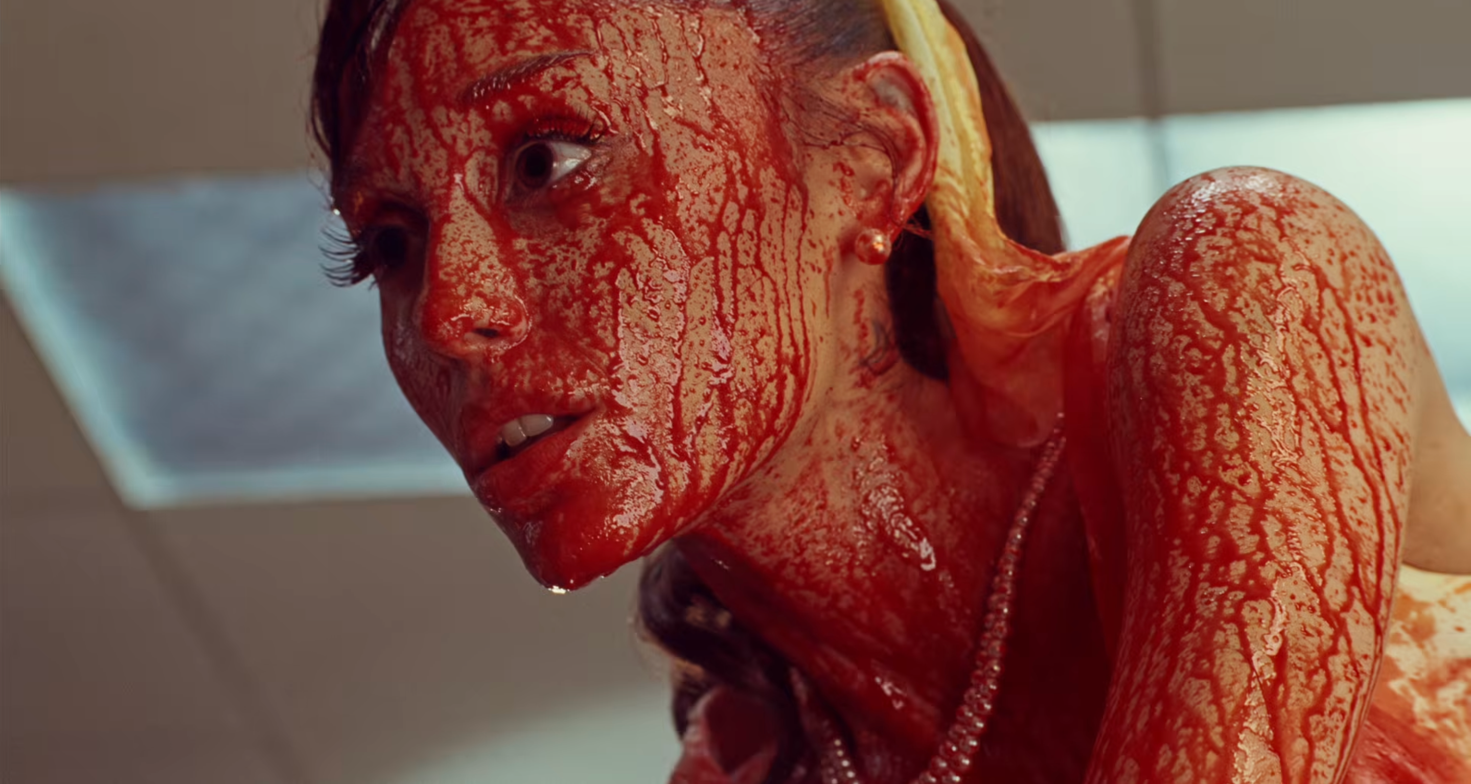 Ariana Grande covered in fake blood in the "Petal" music video