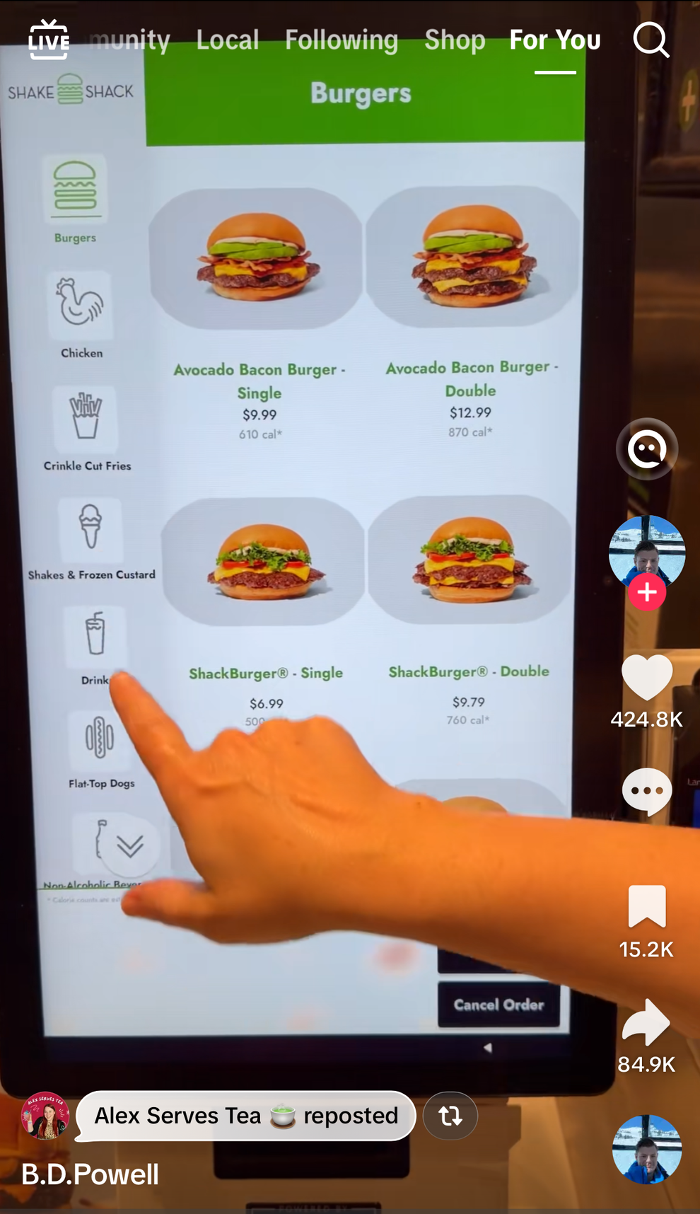 Person pointing at a self-service screen displaying various Shake Shack burger options; interests include no tip increase option