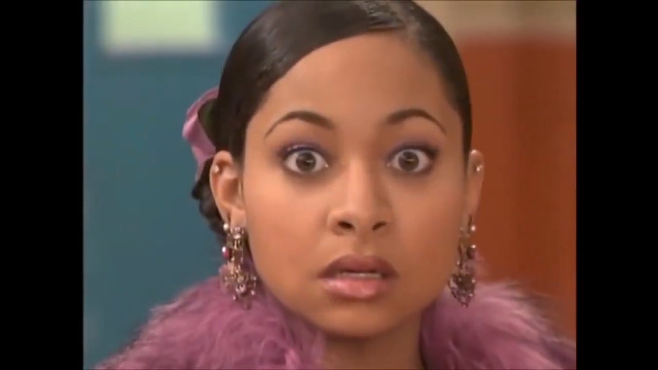 Woman with wide eyes, wearing a fur-trimmed outfit and statement earrings, looking surprised