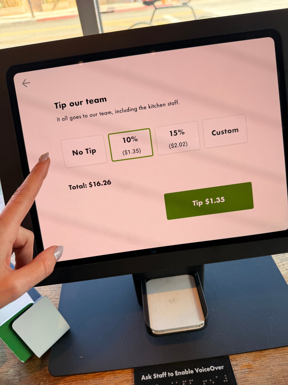 Tablet screen displaying tip options: No Tip, 10% ($1.35), 15% ($2.02), and Custom on a $16.26 total, with a prompt to enable VoiceOver