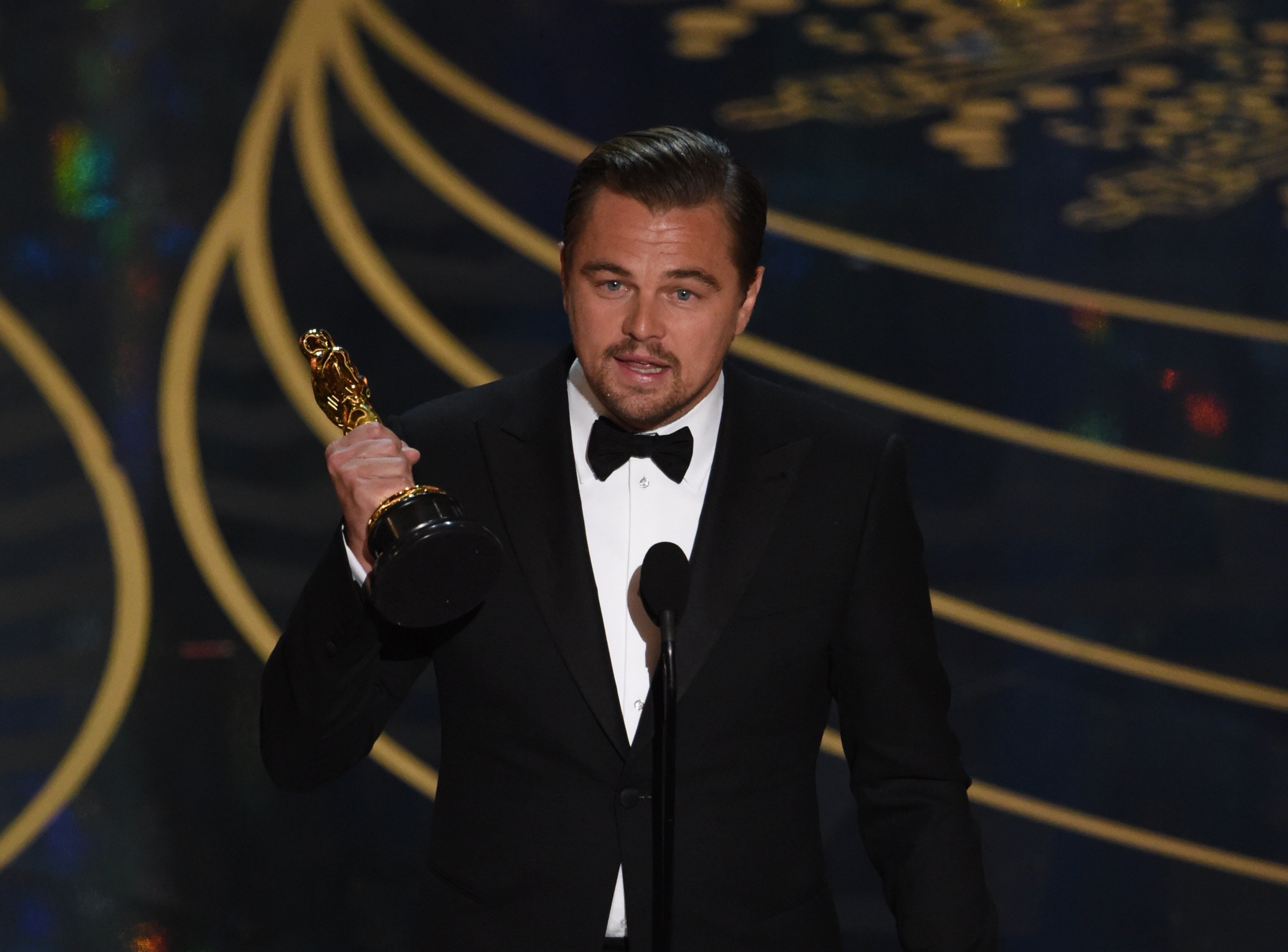 Leonardo DiCaprio accepts the award for Best Actor in The Revenant on stage at the 88th Oscars