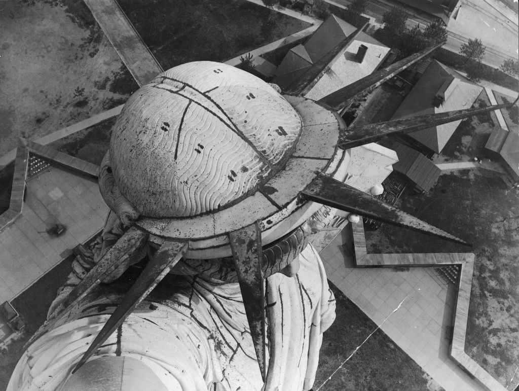 Aerial view of the Statue of Liberty's crown and spikes, overlooking Liberty Island below