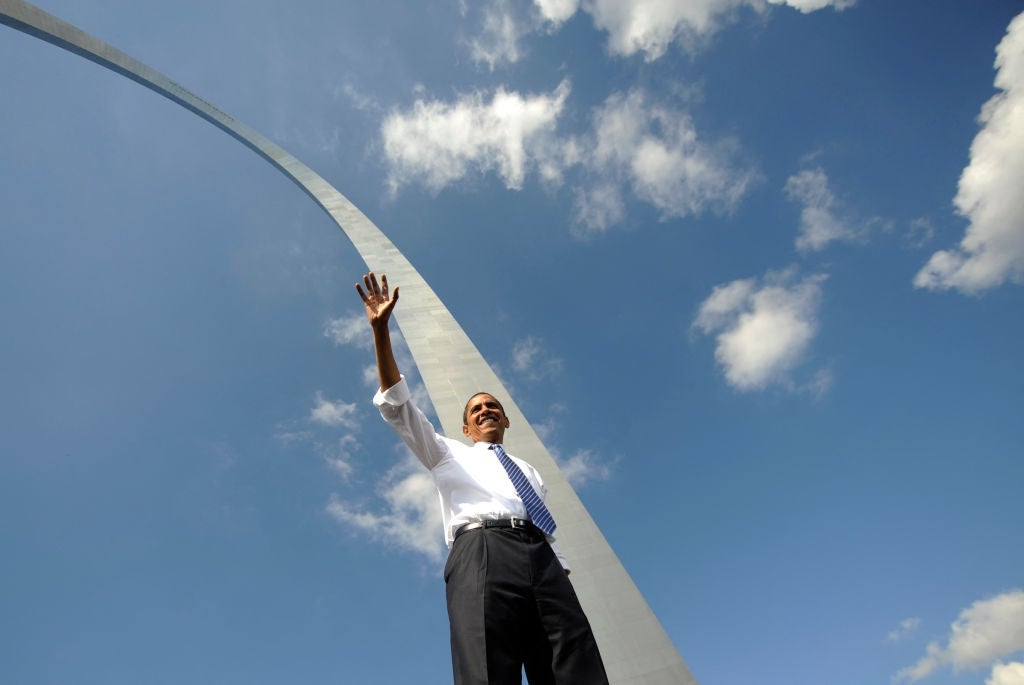 Barack Obama waves during a rally under the Gateway Arch