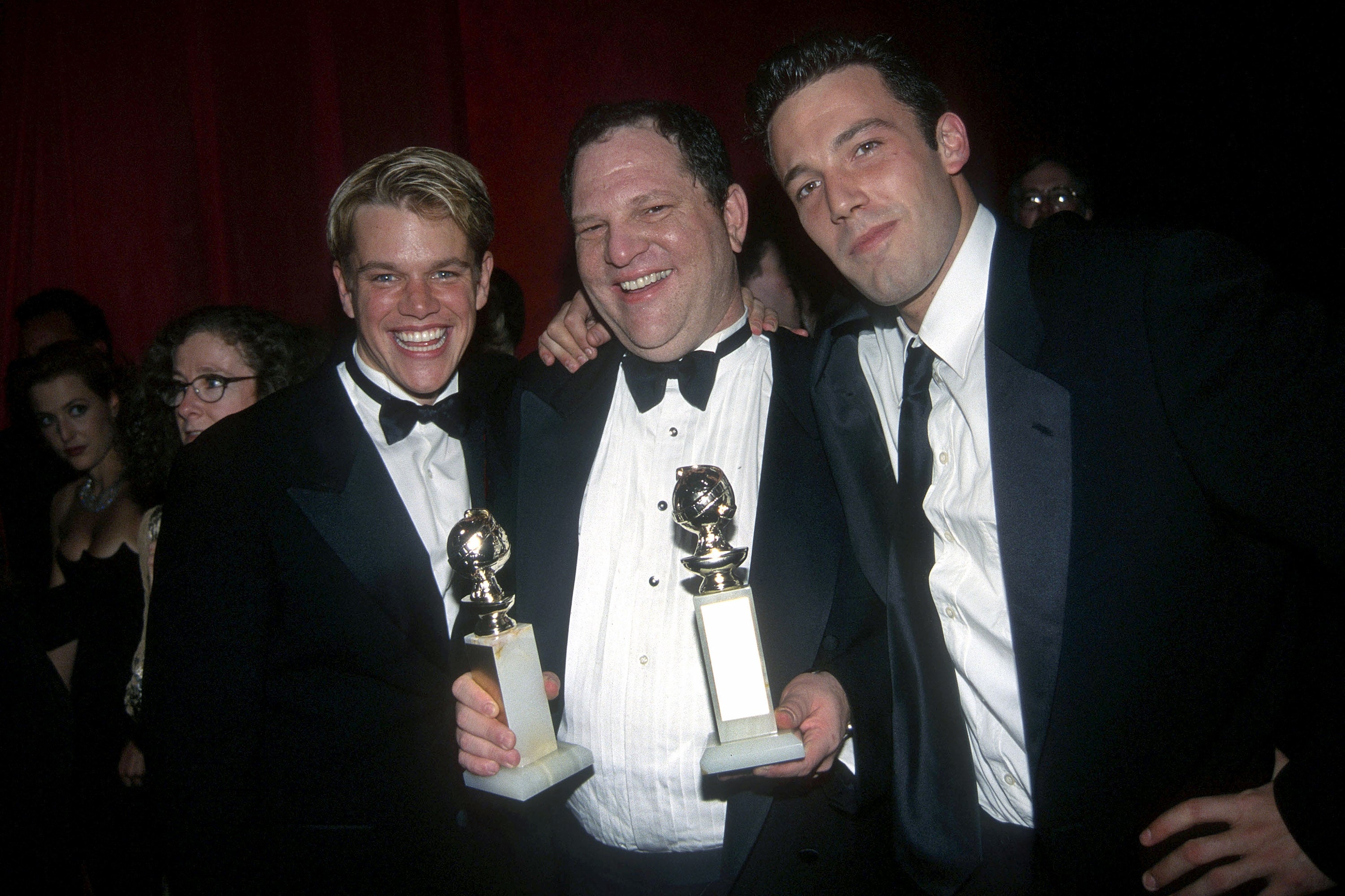 Matt Damon, Harvey Weinstein, and Ben Affleck hold their Golden Globe awards at the Annual Golden Globe Awards After Party