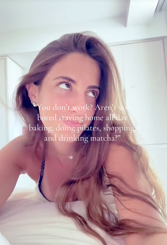 Woman with long hair leans on a surface at home, with text overlay about staying home, baking, doing pilates, shopping, and drinking matcha