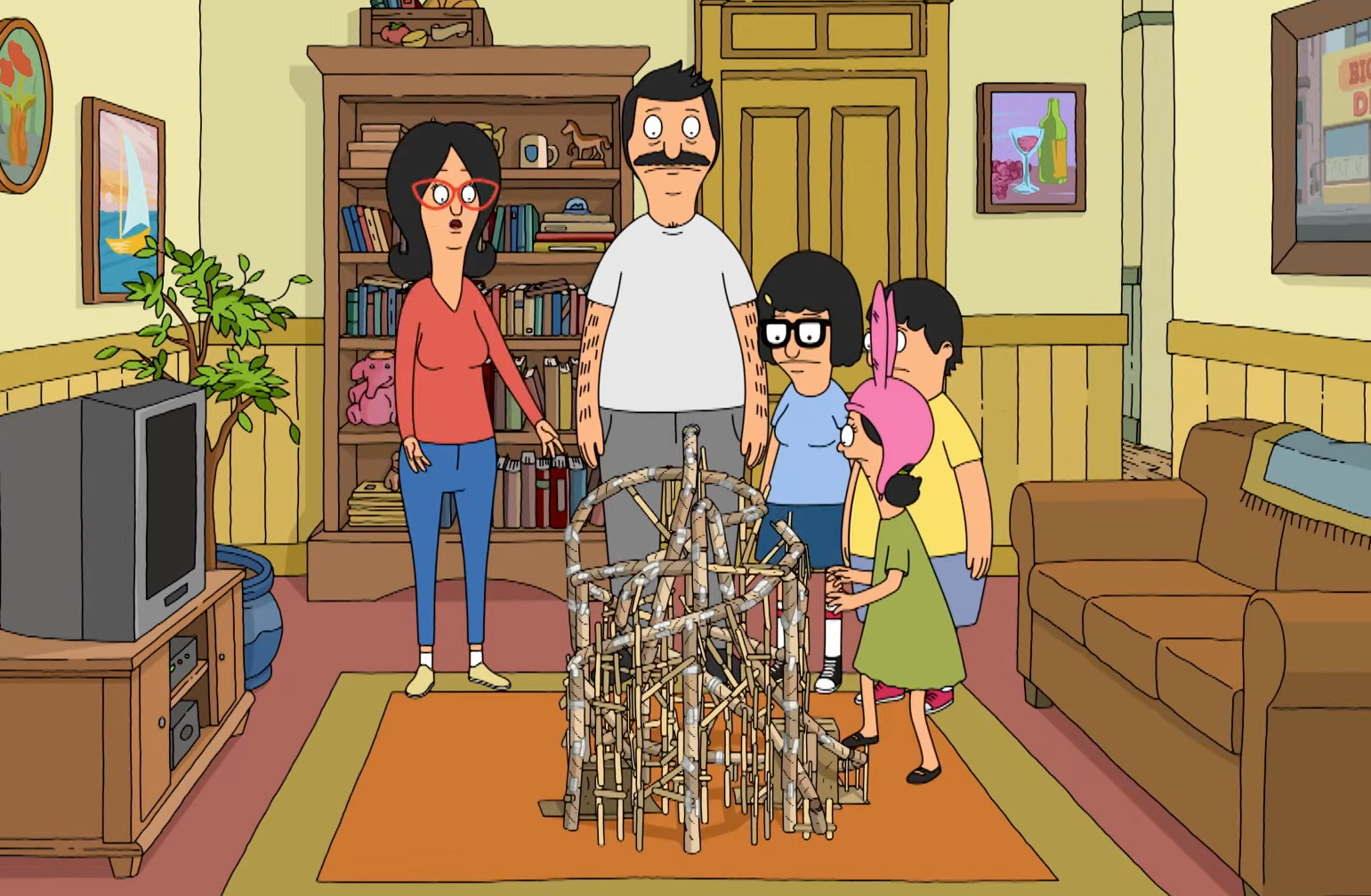 Animated family looks at a large structure made of sticks in their living room, displaying surprise and curiosity