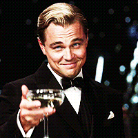 Leonardo DiCaprio as Jay Gatsby, holding a champagne glass as he toasts an elegant party.