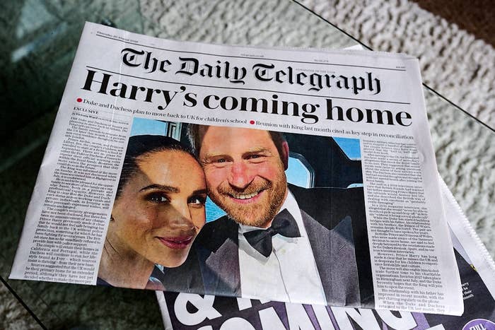 Front page of The Daily Telegraph with headline: "Harry’s coming home." Below is a photo of two smiling people