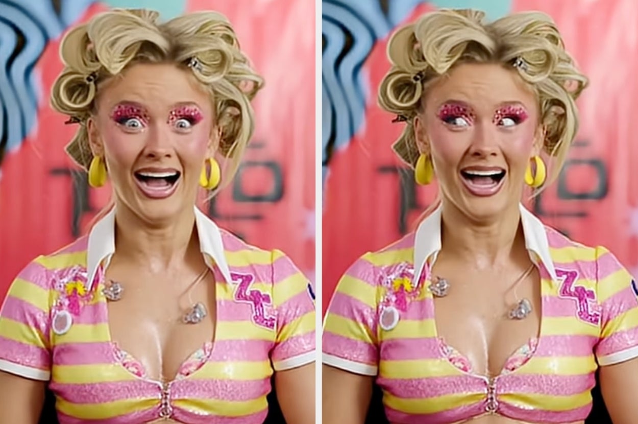 Person with exaggerated makeup and hair rollers, wearing a striped top with letter "Z" detail, posing humorously with wide eyes and open mouth