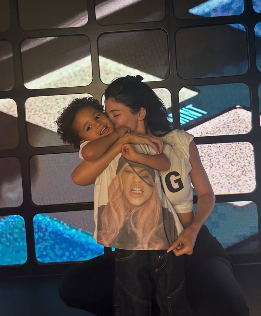 Kylie embracing her child