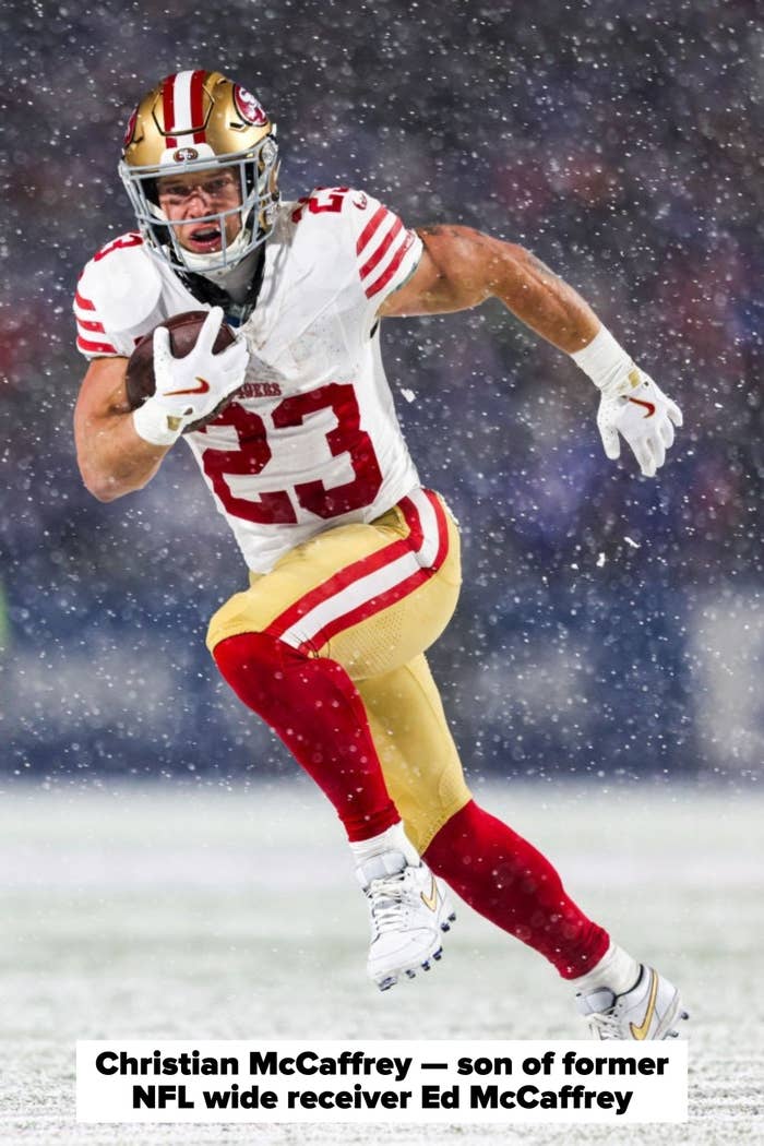 Football player in a dynamic pose running with a ball during a snowy game, wearing a red and gold uniform and helmet