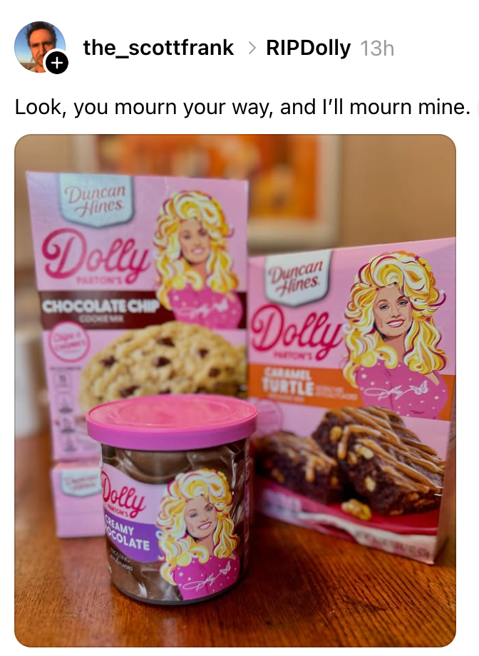 Boxes of Dolly Parton-themed cake mixes and a frosting container with Dolly's likeness. Caption: "Look, you mourn your way, and I'll mourn mine."