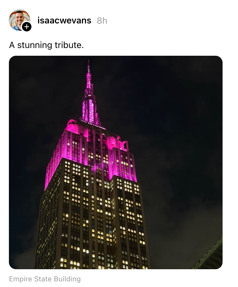 Empire State Building lit in purple at night as a tribute