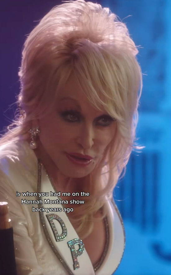 Person with styled hair and embellished jacket speaks, text onscreen reads "when you had me on the Hannah Montana show back years ago."
