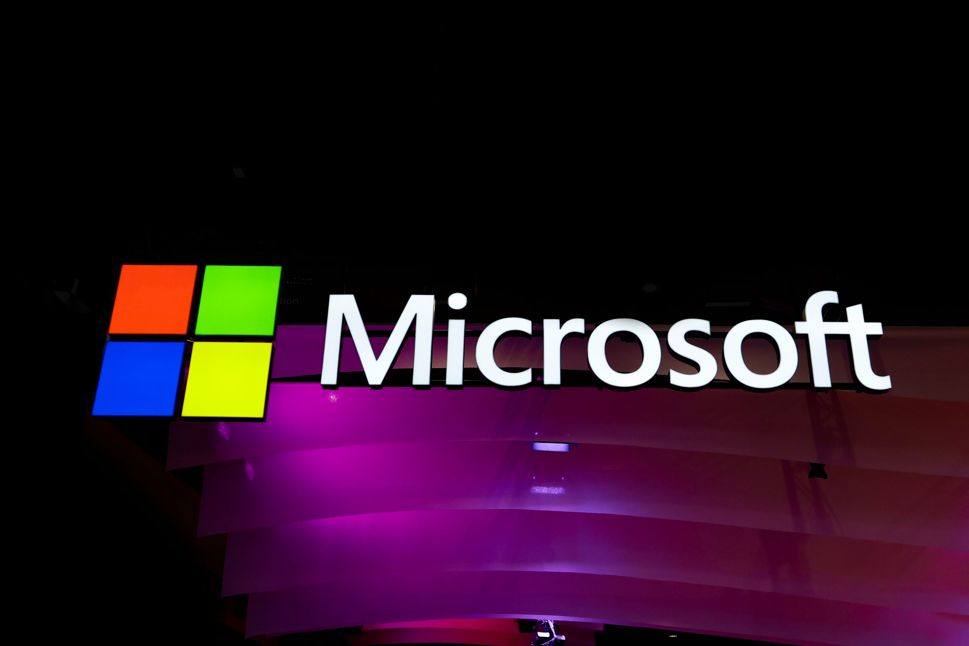 Microsoft logo with a multicolored square icon next to the company's name on a dark background