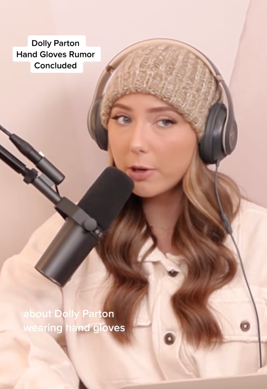 Person in a beanie speaking into a microphone with text mentioning a Dolly Parton hand gloves rumor