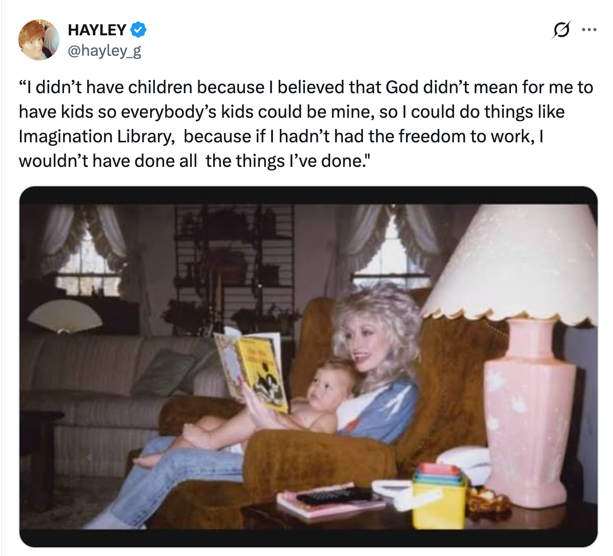A woman with curly hair reads a book to a baby in a cozy living room. A quote about choosing not to have children for personal freedom is displayed above