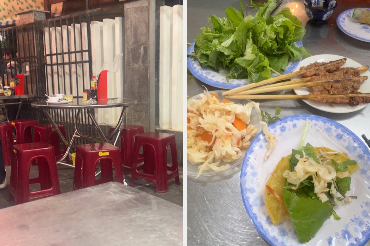Street food setup with small tables and red stools next to a metal fence. Plates feature grilled skewers, fresh greens, and pickled vegetables