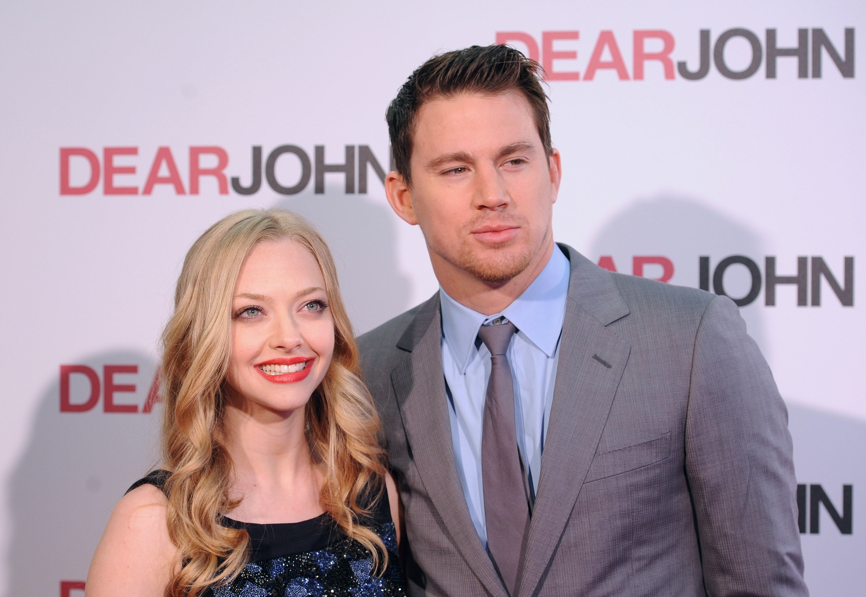 Amanda Seyfried and Channing Tatum posing at a "Dear John" event; Amanda wears a sleeveless dress, and Channing is in a suit and tie