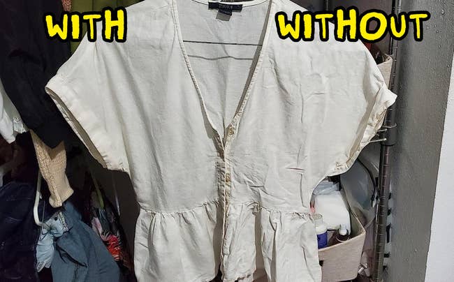 A beige short-sleeve blouse with a ruffled waist hangs in a closet, surrounded by various clothes and items