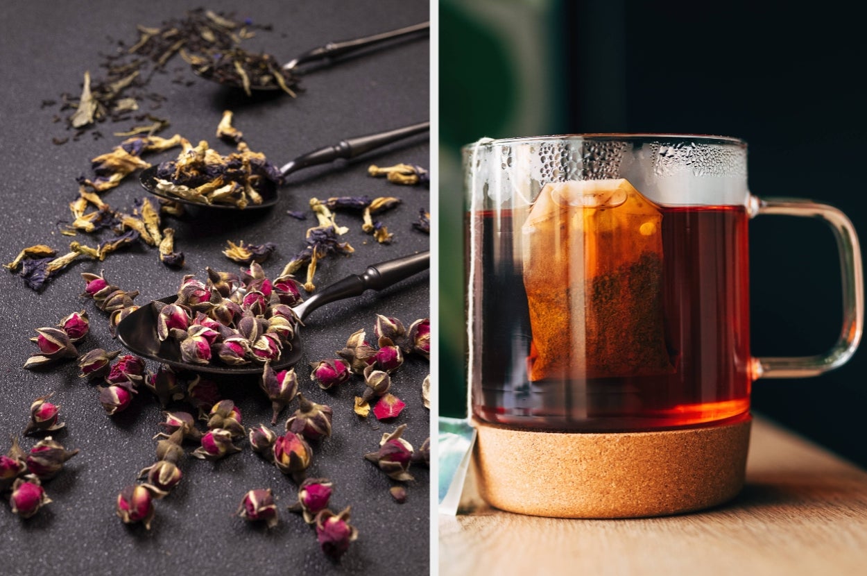 Loose tea leaves and dried flowers on a table, next to a clear mug with a steeping tea bag