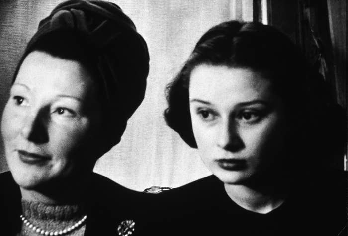 Audrey Hepburn and her mother sitting side by side in formal attire