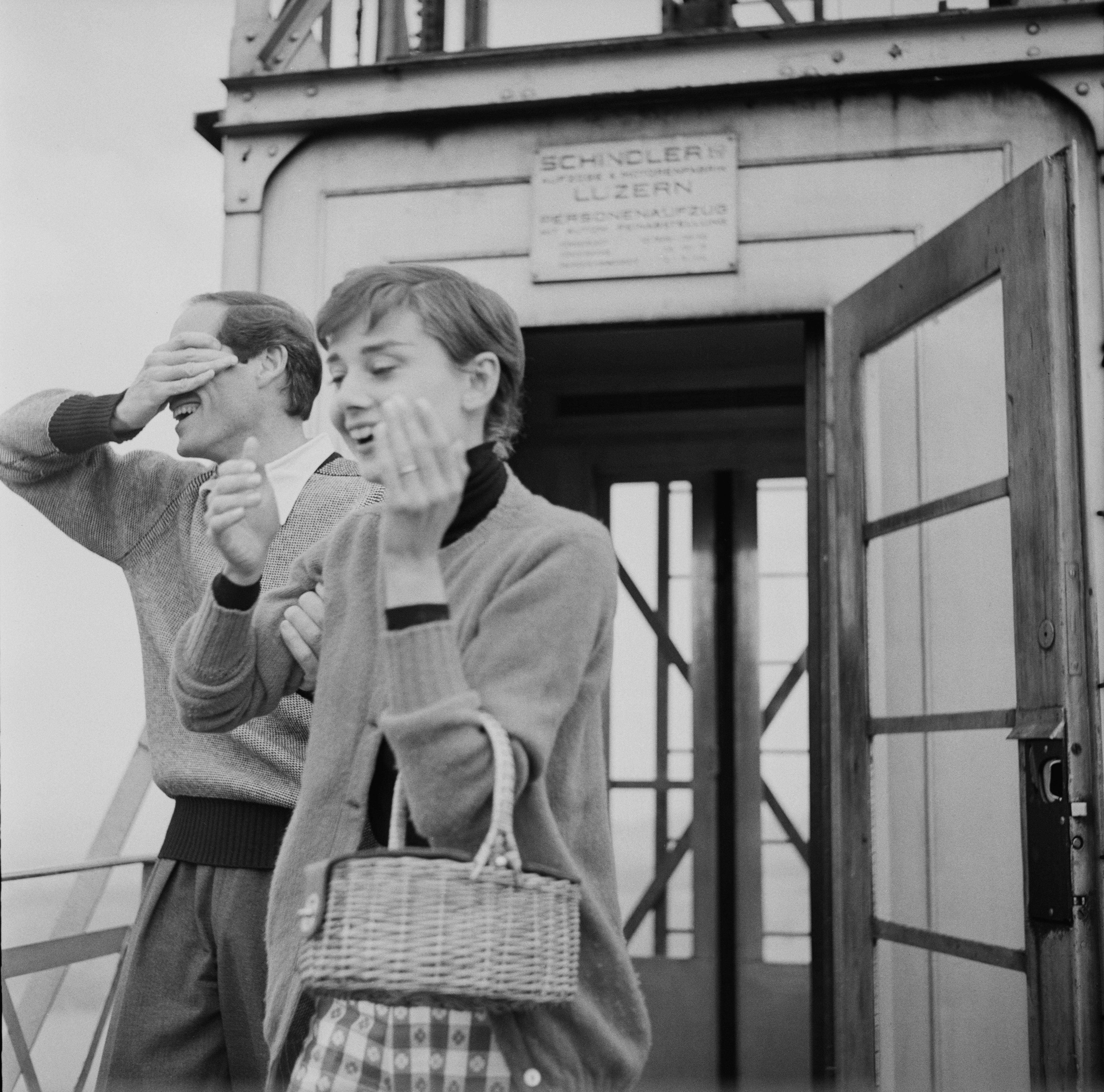 Audrey and Mel laughing outside a building.