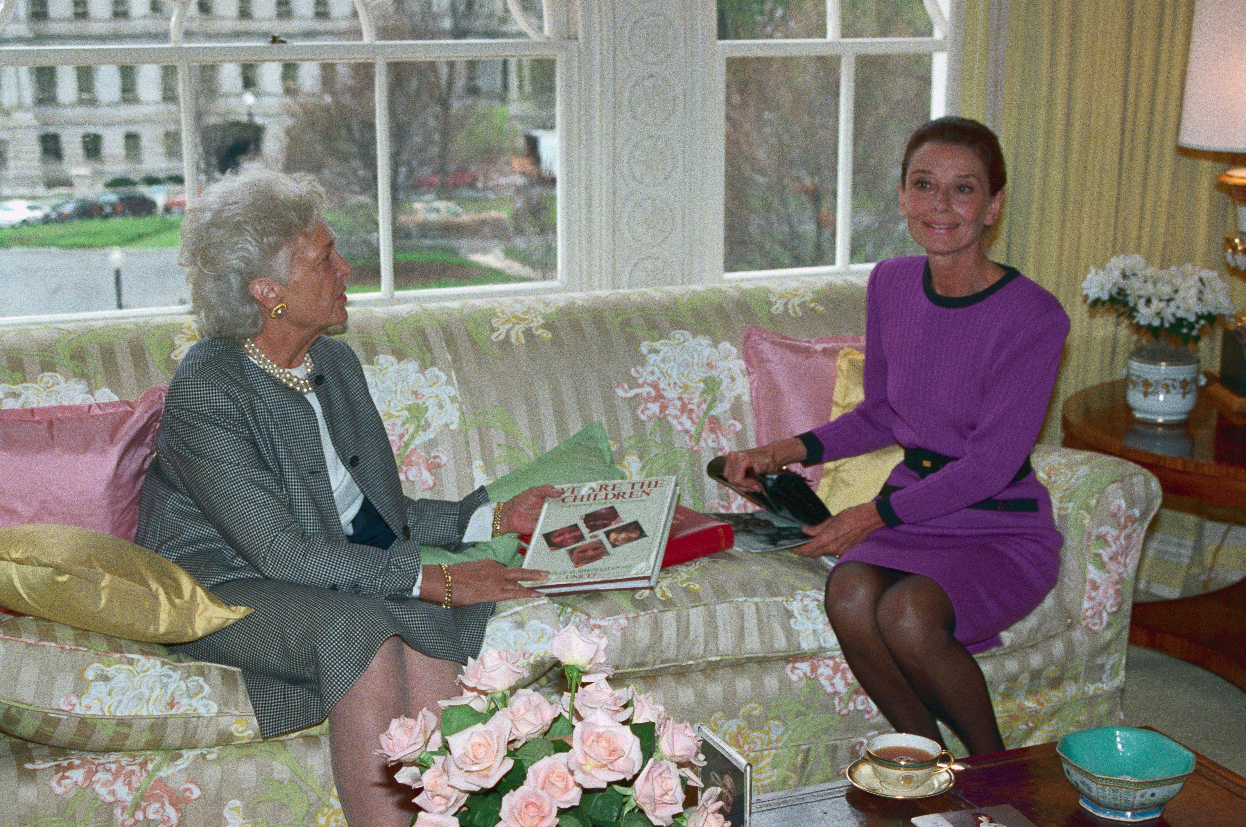 Audrey and Barbara sitting on a sofa in an elegant room