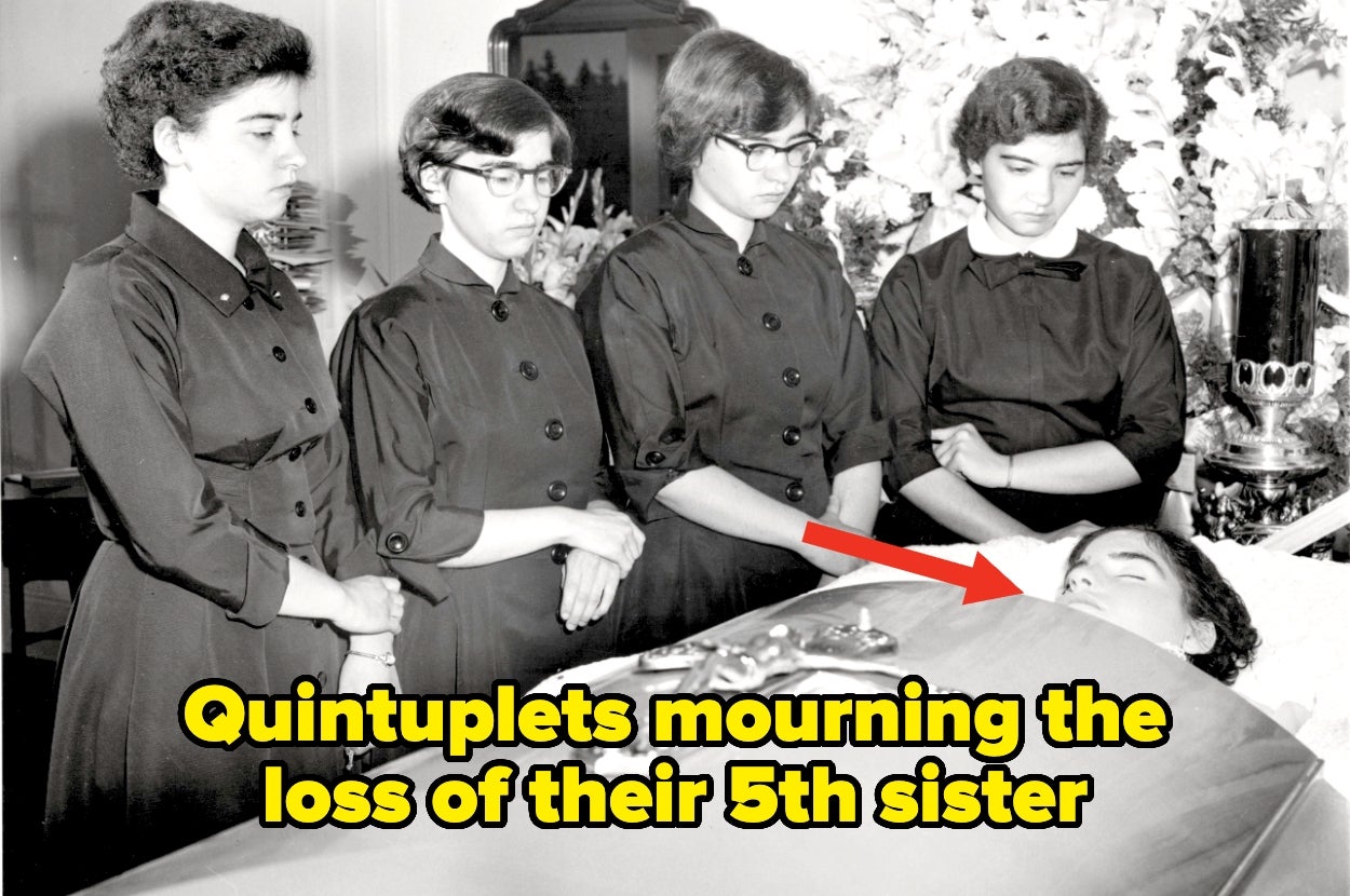 Four women in dark dresses stand solemnly beside a casket, mourning their sister