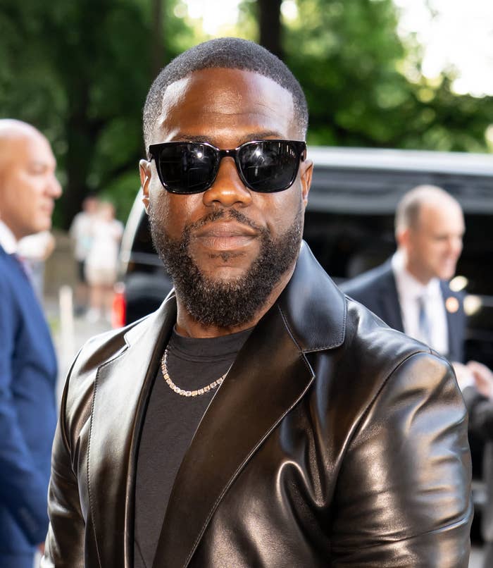 Person wearing sunglasses and a leather jacket at an outdoor event