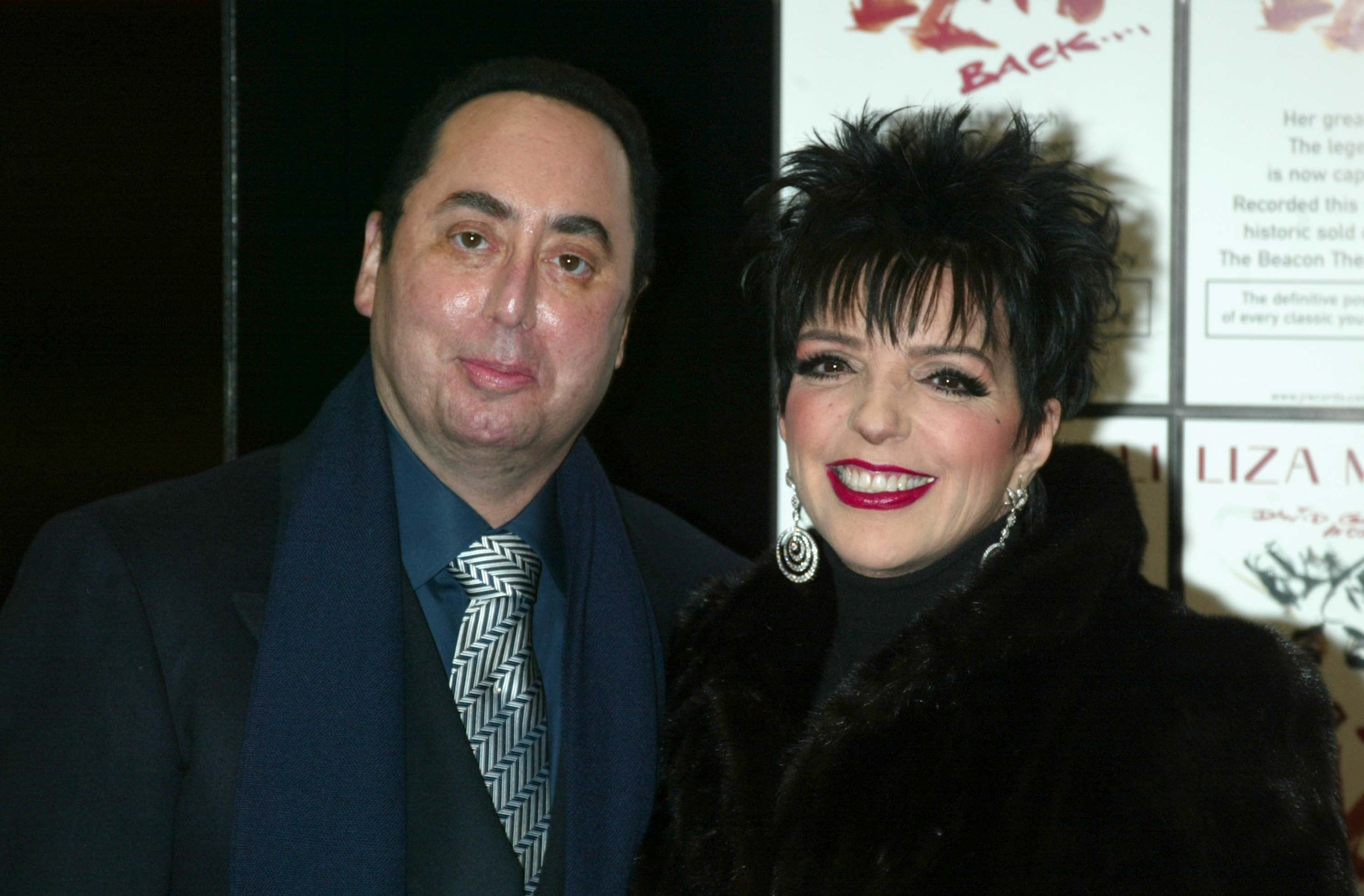 I don’t know who these people are, but they are smiling at an event, dressed in elegant attire
