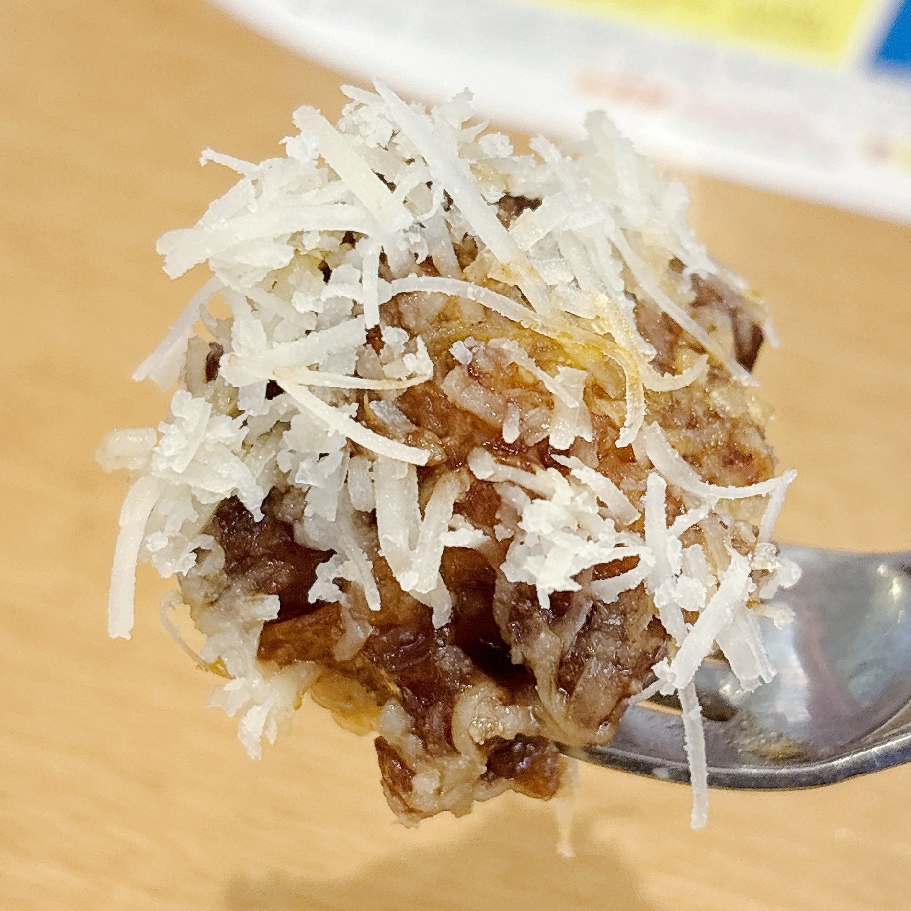 ココス「山盛りチーズの濃厚ビーフシチュー包み焼きハンバーグ145g」フォークの上に載った細かく刻まれたチーズと肉。