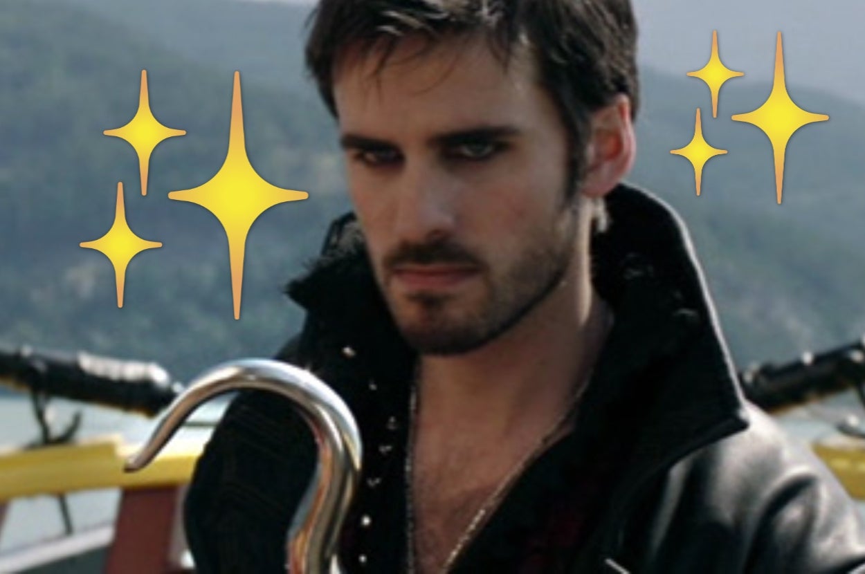 A person dressed as a pirate with a hook hand is outdoors, surrounded by drawn sparkles