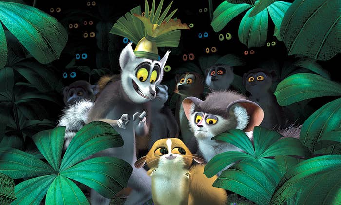 Animated lemurs among jungle leaves, with one wearing a leaf crown in a playful scene from an animated film