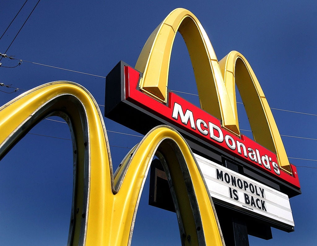 McDonald's sign showing the announcement "Monopoly is back" under iconic golden arches