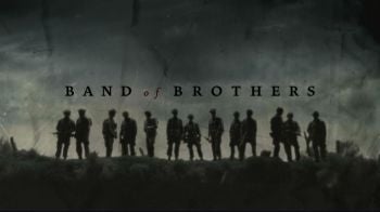 Silhouettes of soldiers standing in a row with "Band of Brothers" text above them. Dark, overcast background