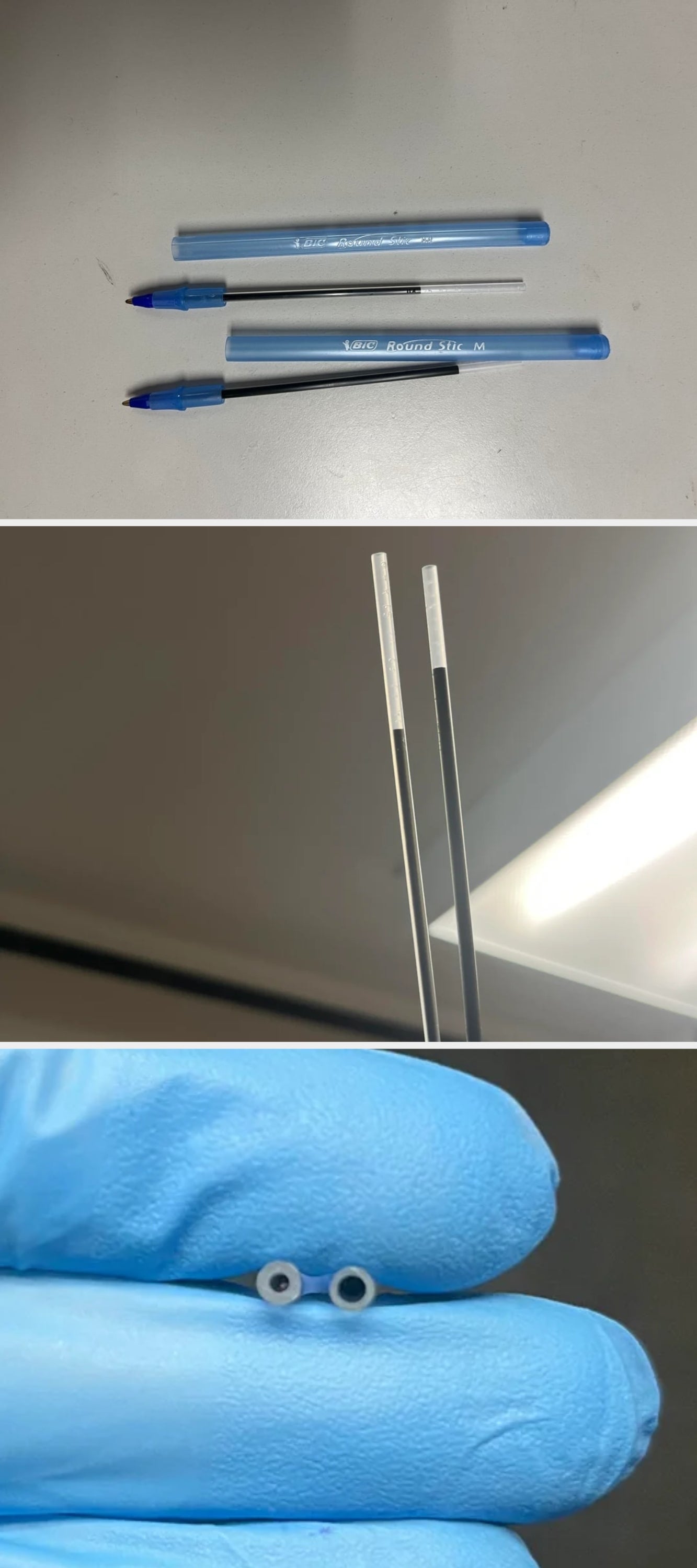 Three disassembled ballpoint pens with bluish  caps and wide   barrels placed connected  a airy  surface