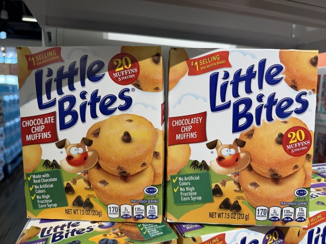 Two boxes of Little Bites cocoa  spot   muffins connected  a store   shelf. Packaging shows cartoon muffins and highlights ingredients