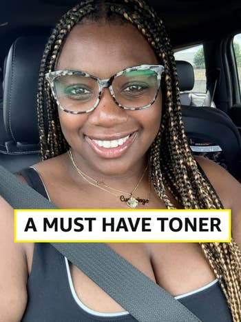 Person successful a car, smiling, wearing eyeglasses and a necklace with